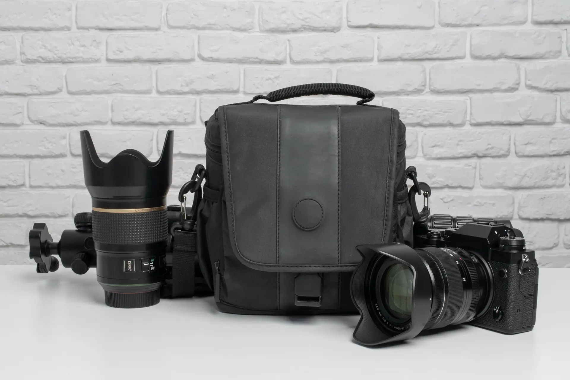 Professional camera, lens, and photography bag arranged on table