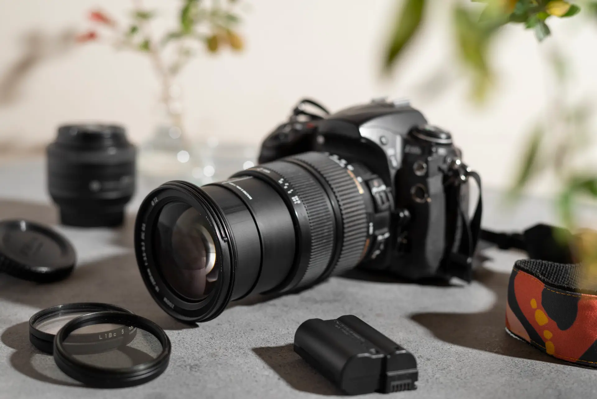 Professional camera, lens, and photography accessories arranged on studio table