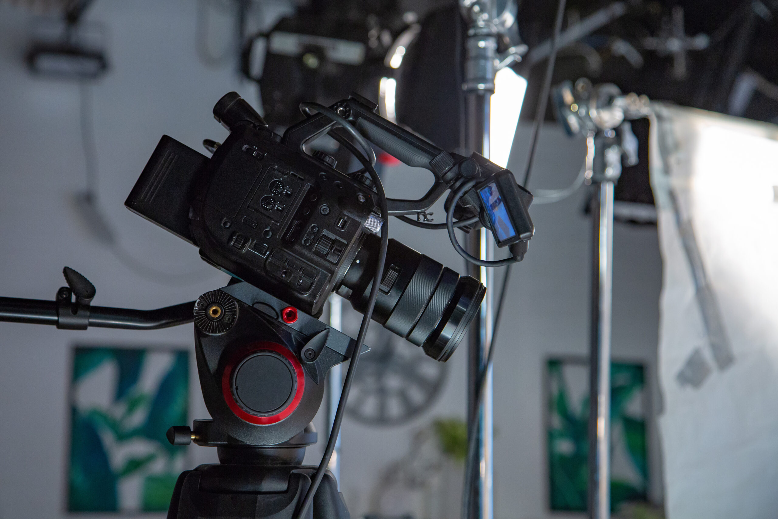 Professional video camera mounted on tripod inside a studio setup