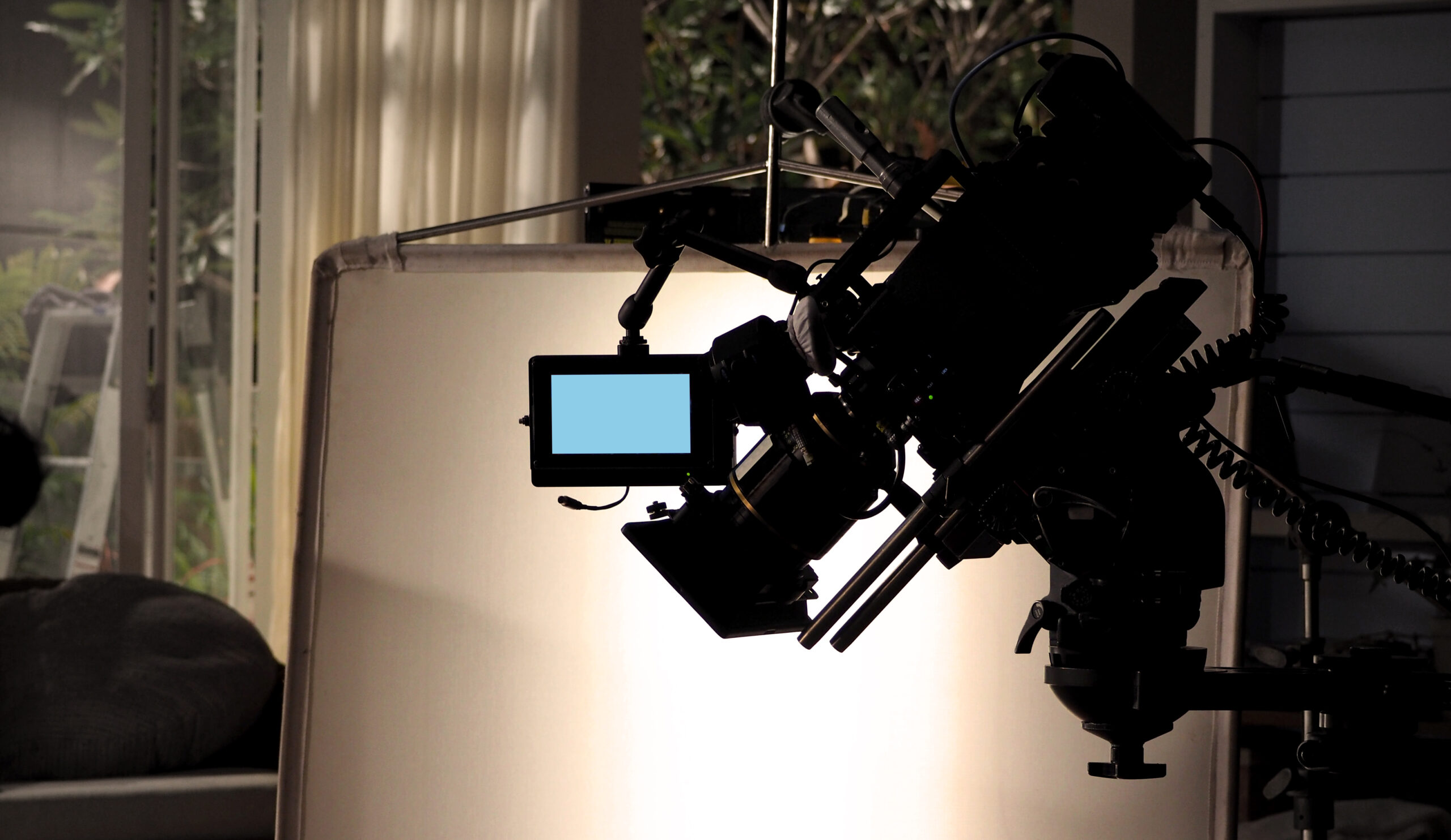 Silhouette of professional cinema camera in studio lighting setup