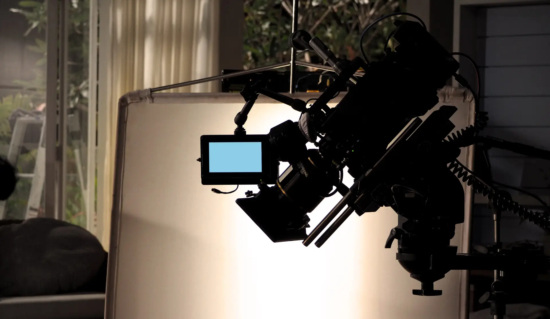 Silhouette of professional cinema camera in studio lighting setup
