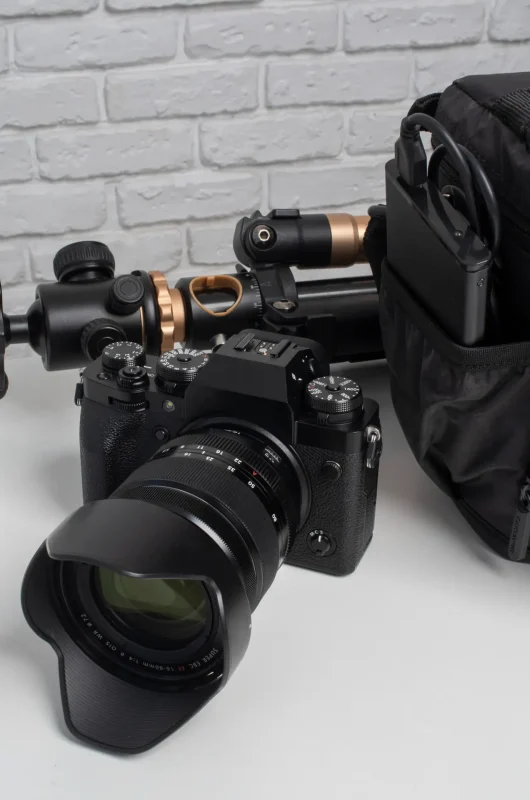 Professional DSLR camera with photography accessories and equipment placed on a table