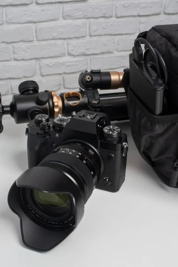 Professional DSLR camera with photography accessories and equipment placed on a table