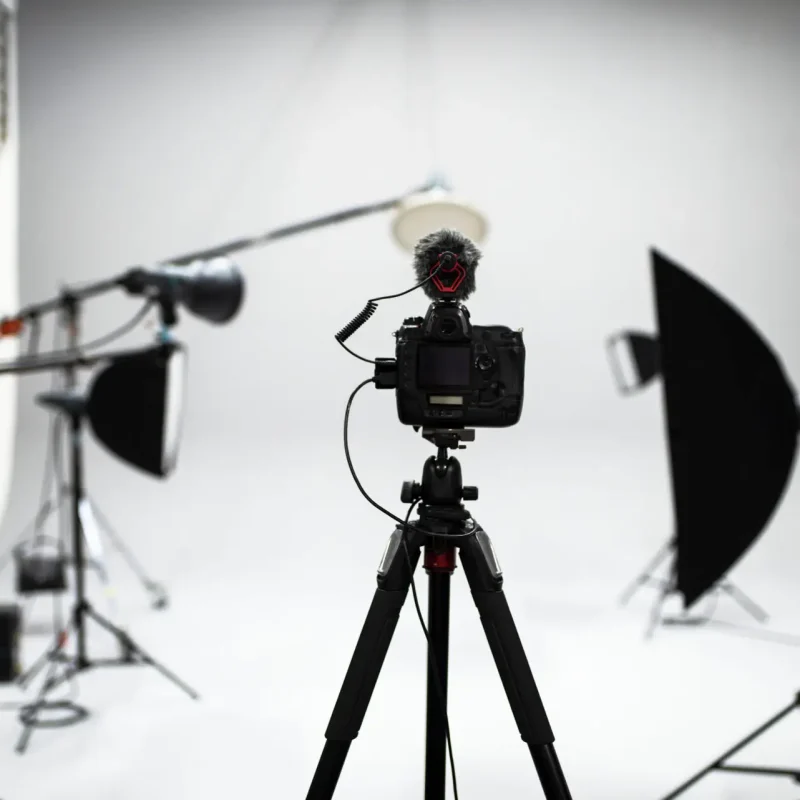 Professional camera with microphone setup inside a modern photography and video production studio